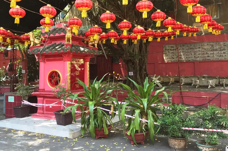 The temple grounds hang many brilliant red lanterns