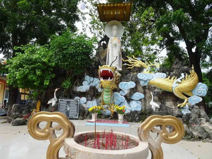 Statue of Avalokiteshvara sitting on a dragon's back
