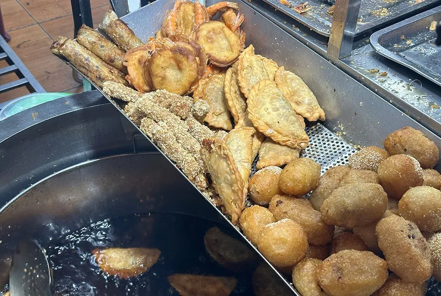 The cake is deep-fried in oil to create an even crispiness
