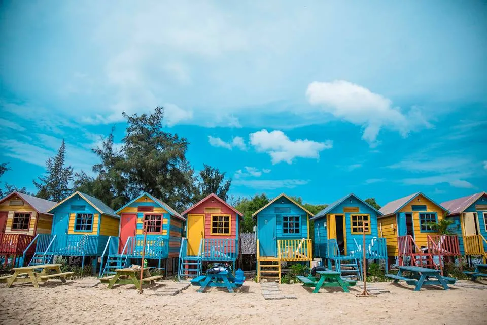 colorful wooden huts in coco beach camp
