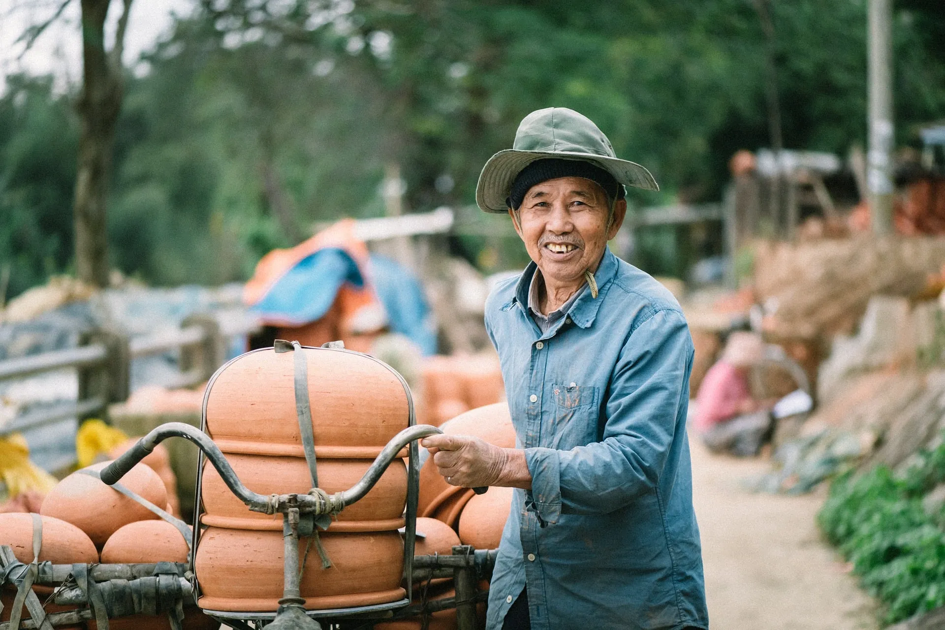 smiling Vietnamese old man with his pottery