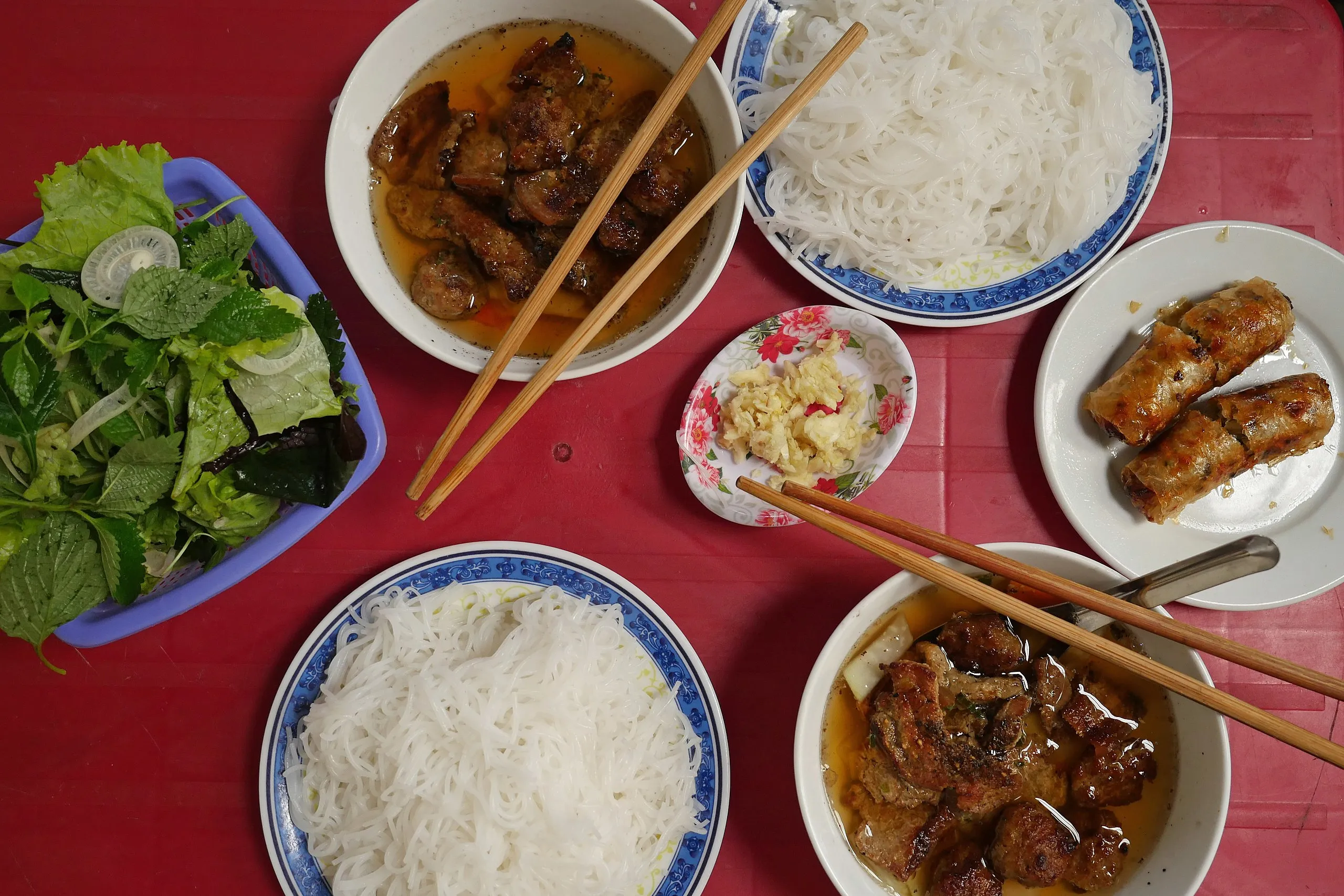 Table full of bun cha ingredients