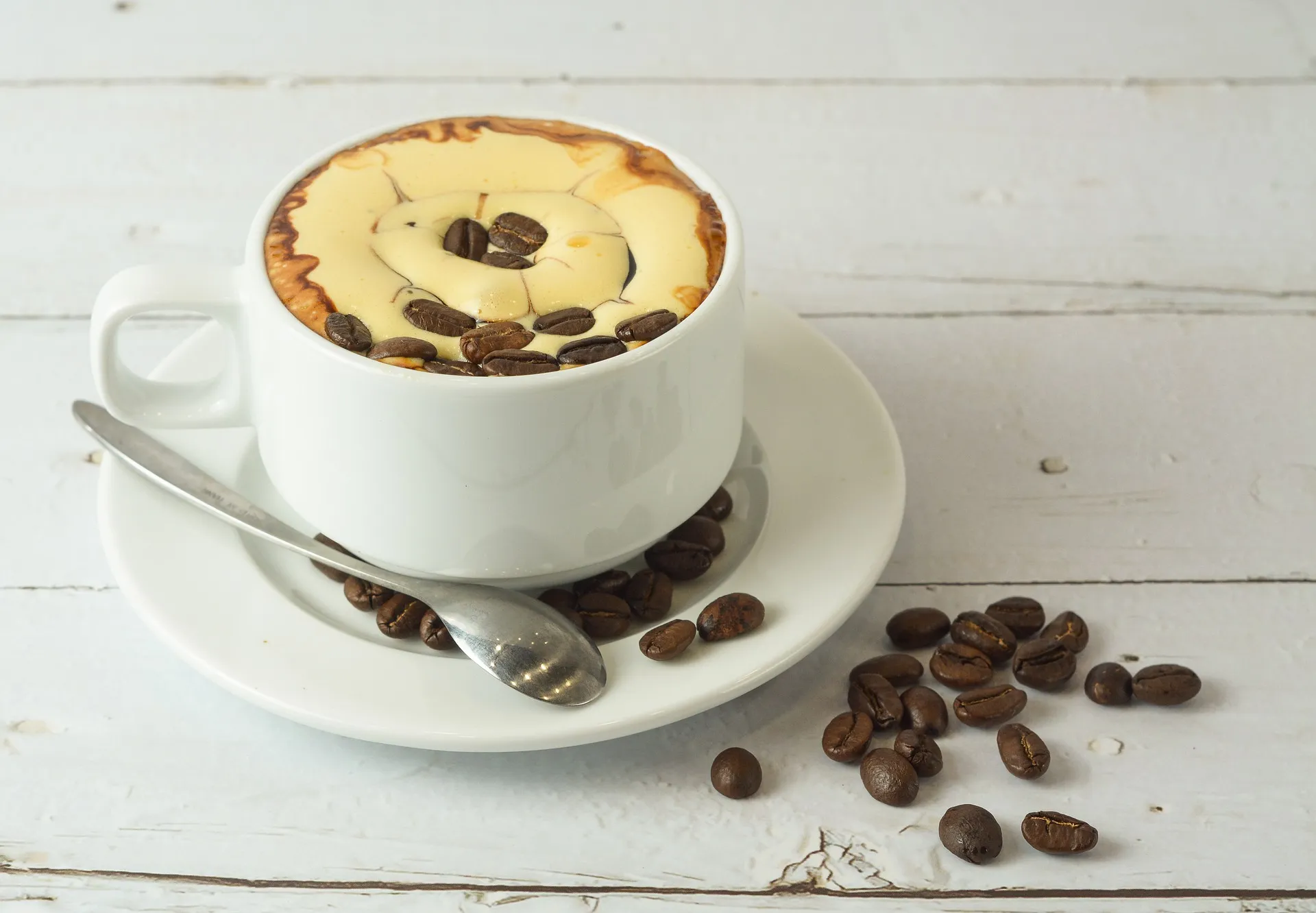 A cup of egg coffee with coffee beans