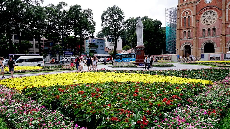 The park is filled with colorful flowers in front of the church