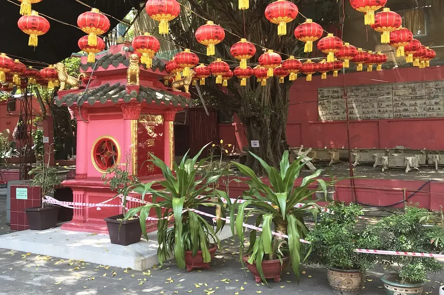 The temple grounds hang many brilliant red lanterns