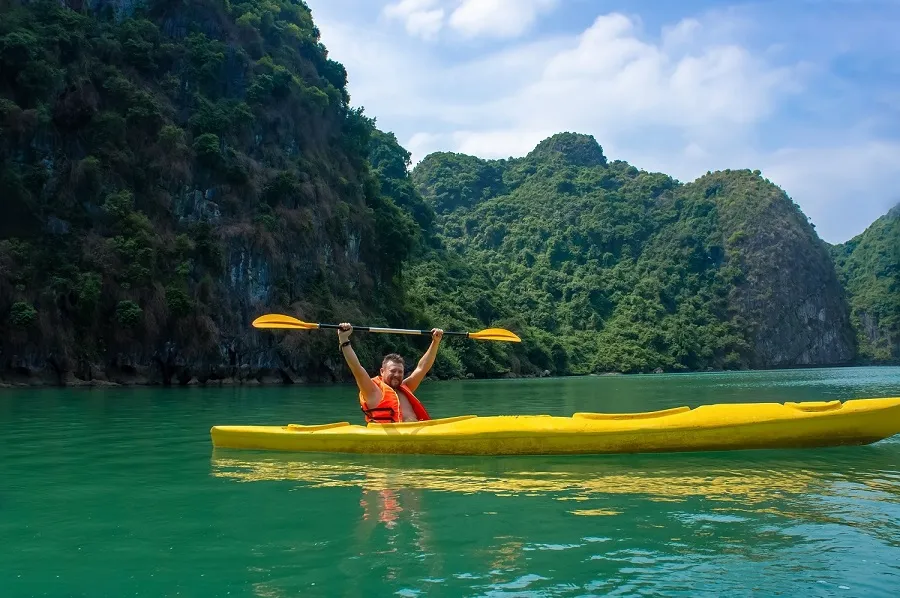 Kayaking in the midst of green mountains and blue water